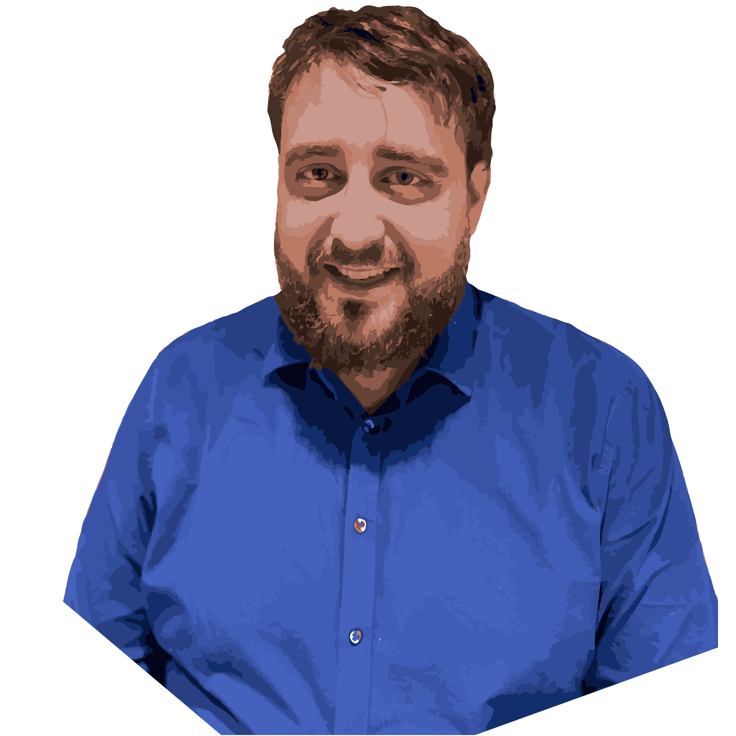 Man in a blue shirt with a beard, smiling at the camera.